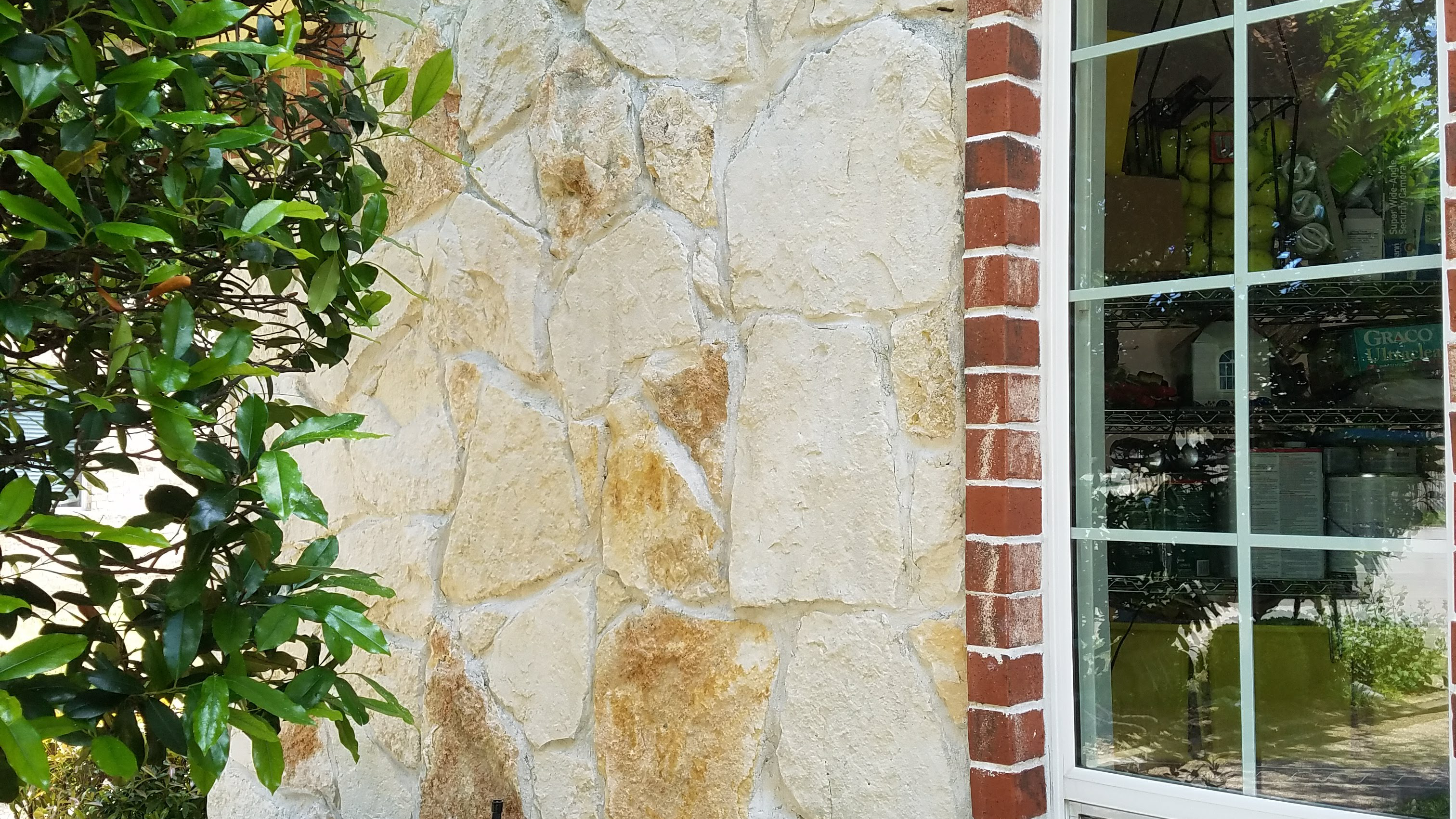 An image of a stone wall after being power washed.